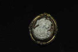 An antique yellow metal cameo brooch with rotating central panel, 52 mm x 44 mm.