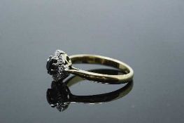 An 18ct gold diamond set sapphire ring, size Q.