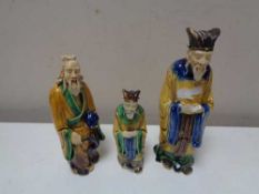 Three twentieth century glazed pottery figures of Chinese elders