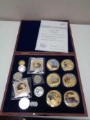 A case of fourteen assorted coins, gold plated James Cook collection with certificate, St.