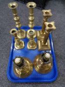 A tray of four pairs of brass candlesticks