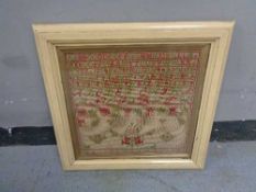 A nineteenth century framed alphabet sampler dated 1880