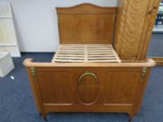 A 4'6 antique inlaid French oak bed frame with brass mounts