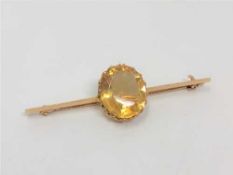 A 15ct gold bar brooch set with a large citrine CONDITION REPORT: 3.