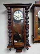 An early twentieth century mahogany eight day wall clock with brass and enamelled dial