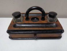 An Edwardian desk stand fitted a drawer and two glass ink wells