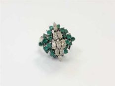 An 18ct gold emerald and diamond cluster ring,