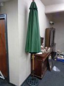 A garden parasol on cast iron stand