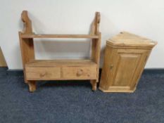 A pine wall shelf fitted with two drawers together with a small pine cabinet