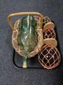 A tray of glass bottle in wicker basket,