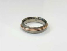 A gent's titanium and rose gold band ring,