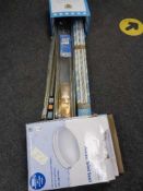 A box of curtain rails,