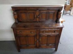 An Ercol buffett backed sideboard 124 cm wide, 125 cm height and 48 cm depth.