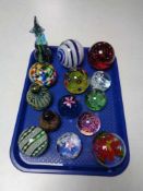 A tray of glass paperweights,