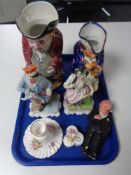 A tray of continental figurines, Toby jug, pottery figure,