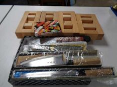 A tray of Japanese chef knives and wooden sushi stands