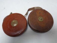 A vintage leather cased Chesterman tape measure together with one other