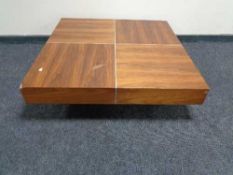 A contemporary square low coffee table in walnut finish
