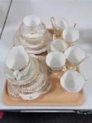 A tray of Windsor gilded bone china tea service and one other service