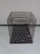 A folding black metal dog cage, height 70 cm, width 68 cm, depth 84 cm.