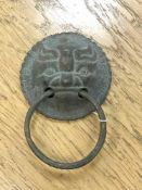 An antique Chinese bronze door handle, diameter 9.5 cm, total drop from top to bottom 14 cm.
