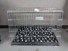 A folding black metal dog cage, height 67 cm, width 86 cm, depth 56 cm.