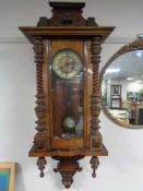An early twentieth century mahogany cased eight day wall clock with brass and enamelled dial