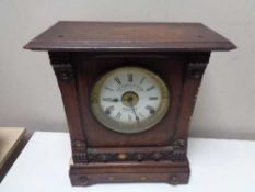 An Edwardian oak cased mantel clock with silvered and enamelled dial by Fattorini and Sons,