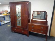 An Edwardian inlaid mahogany mirrored wardrobe fitted with a drawer and a two drawer dressing chest