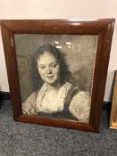 A monochrome print in a mahogany framed depicting a woman