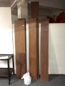 Seven twentieth century teak wall shelves with metal brackets.