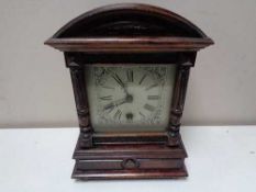 An early twentieth century HAC stained pine eight day mantel clock with silvered dial