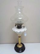 A Victorian brass and pottery Hinks number 1 oil lamp with clear glass chimney and shade