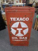A mid century metal work shop cabinet fitted with shelves with Texaco hand painted decoration