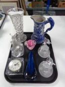 A tray of glass, quartz mantel clock, paper weight, dolphin figures,