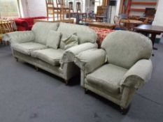 A two seater settee and armchair in green classical print