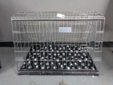 A folding black metal dog cage, height 52 cm, width 82 cm, depth 50 cm.