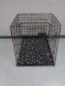 A folding black metal dog cage, height 70 cm, width 68 cm, depth 84 cm.