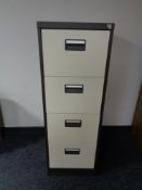 A four drawer metal filing cabinet with key