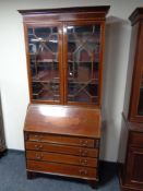 A Victorian inlaid mahogany bureau bookcase on bracket feet