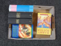 A box of five Harry potter volumes to include Half Blood Prince (first Edition with printing error).