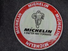 A circular metal sign - Michelin