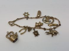 A 9ct gold charm bracelet and one loose charm CONDITION REPORT: 14.