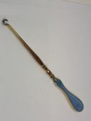 A silver gilt and enamelled button hook