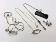 Two silver pendants on chains, another silver mounted pendant, silver earring,