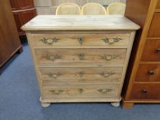 An antique stripped pine four drawer chest