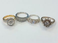Four white metal dress rings