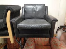 A mid century Danish black leather armchair
