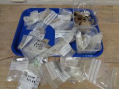 A tray of metal detector finds including coins, bullet casings, bottle stopper,