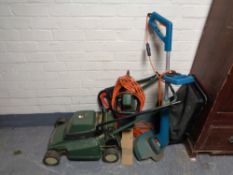 A Black and Decker stripe master electric lawn mower together with electric hedge trimmer and